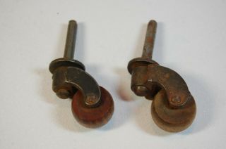Two (2) Vintage Antique Small Metal Casters With Wood Wheels