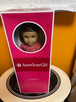 American Girl Doll Chrissa And Book.  Goty 2009 Retired,  Never Removed From Box