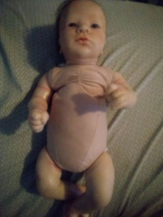 Realistic Silicone Baby Doll With Blue Eyes And Patterned Heart One Piece.
