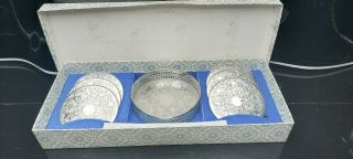 A Set Of 6 Vintage Silver Plated Coasters And Bottle Coaster.  Engraved Patterns.