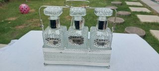 A Vintage Silver Plated Queen Ann Decanter Set With Stand And Labels.  Ornate.