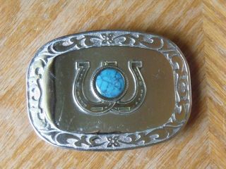 Silver Tone Belt Buckle With 2 Gold Tone Horse Shoes And A Round Turquoise Color
