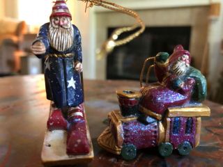 2 Santa Christmas Tree Ornaments:1 - Santa On Train 2.  5 " ; 2 - Santa On Moon Rocker