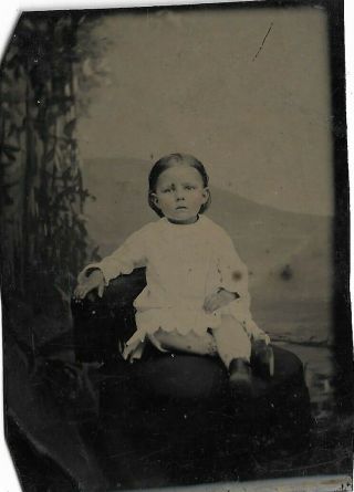 Cute Antique Tintype Photograph Showing Little Girl On Chair Legs Crossed White
